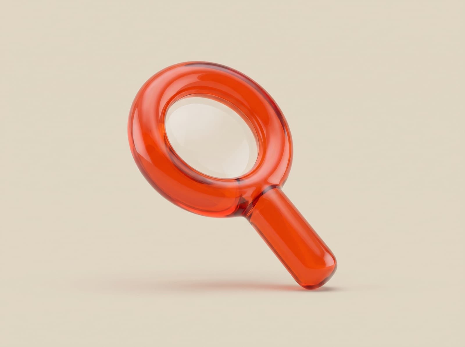 A magnifying glass sculpted in glossy orange glass on a warm sand background